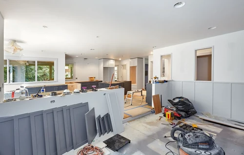 An open floor plan kitchen and dining room being renovated.